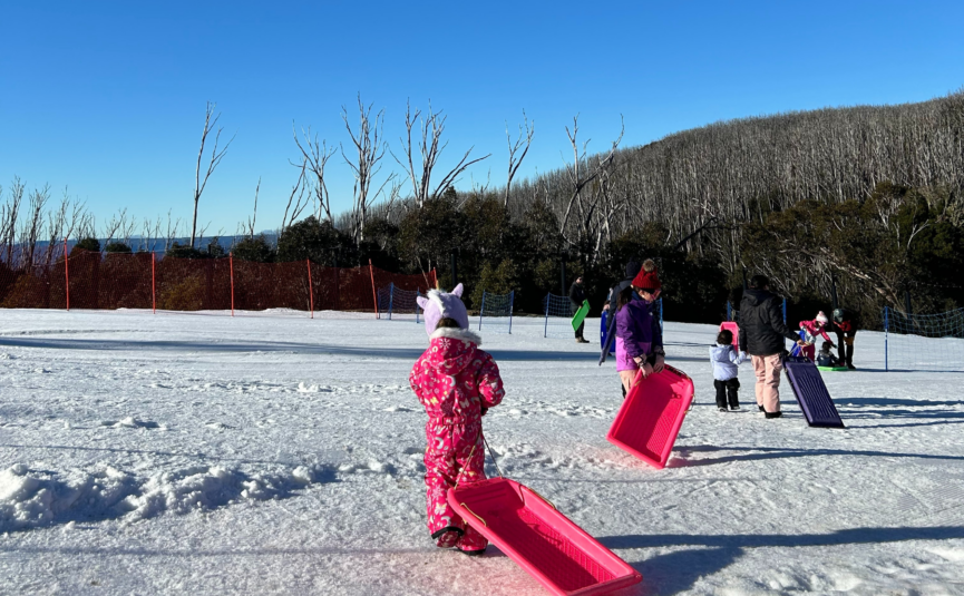 girl-tobogganing-on-snow-news-story-2560x1707 girl pulling toboggan