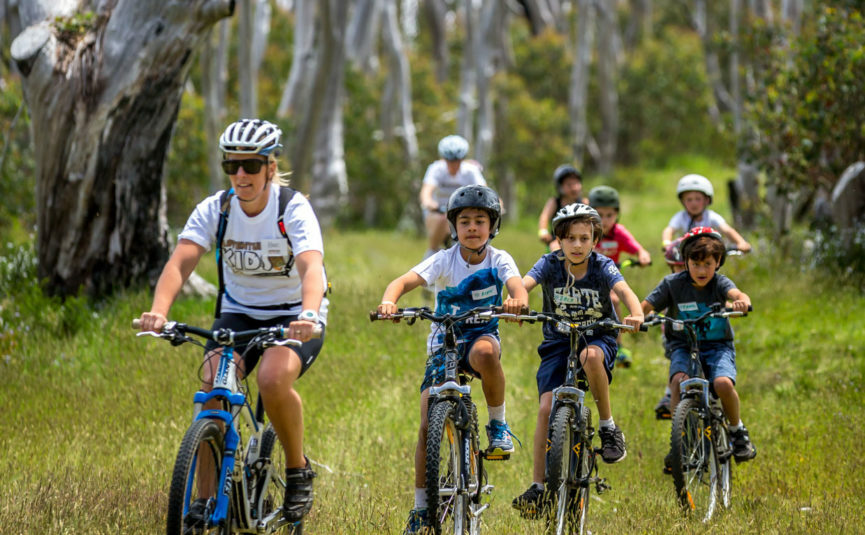 a family mountain biking in nature