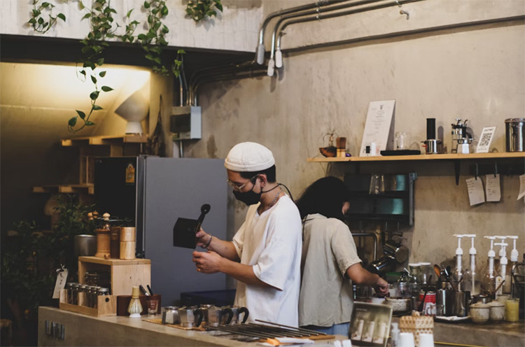 a barista making a coffee at a local cafe