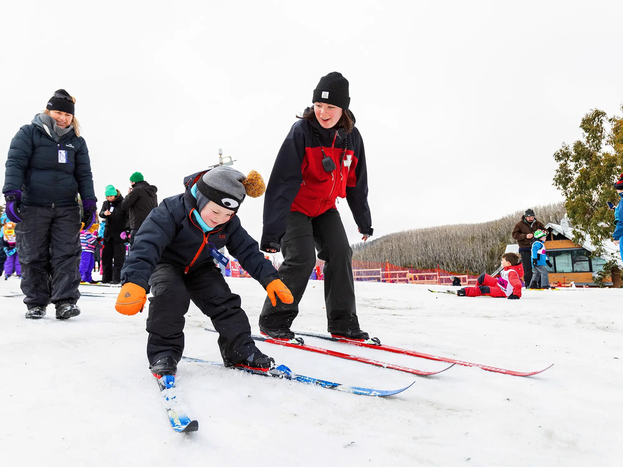 Staff supervising kid on cross-country skiing