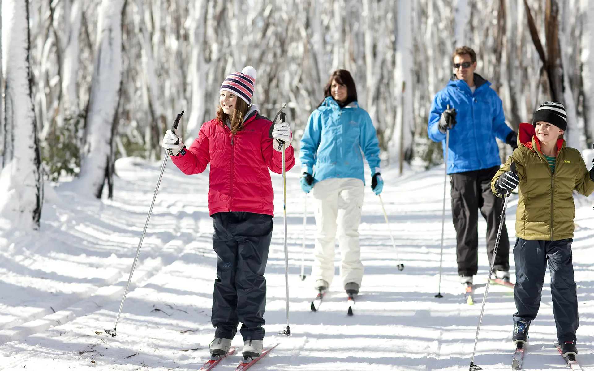 Family of four cross-country skiing